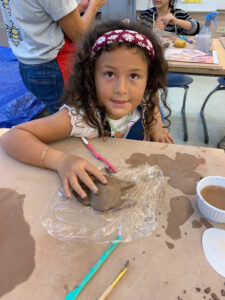 girl in pottery class
